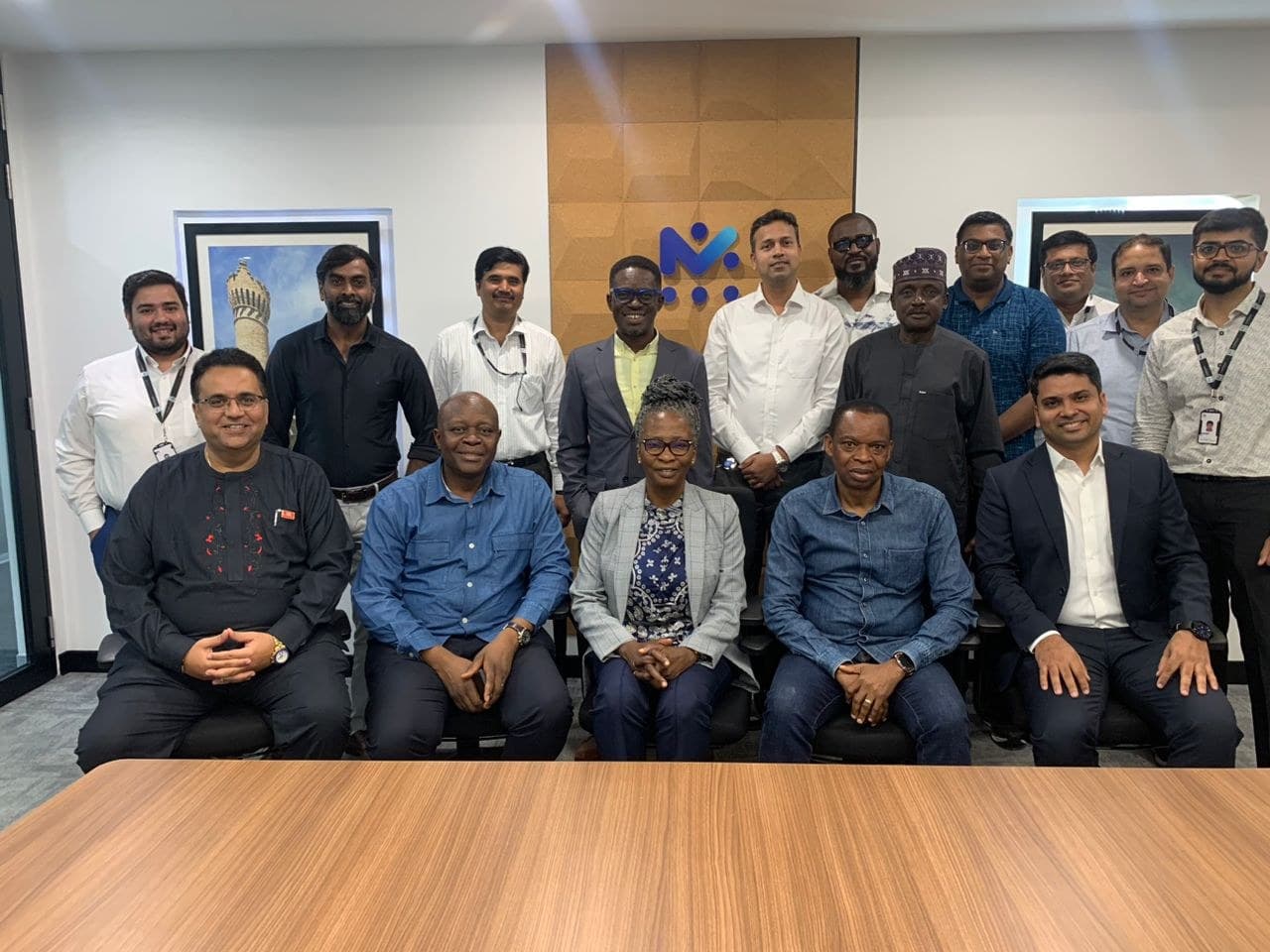 Formal boardroom group photo of the full delegation