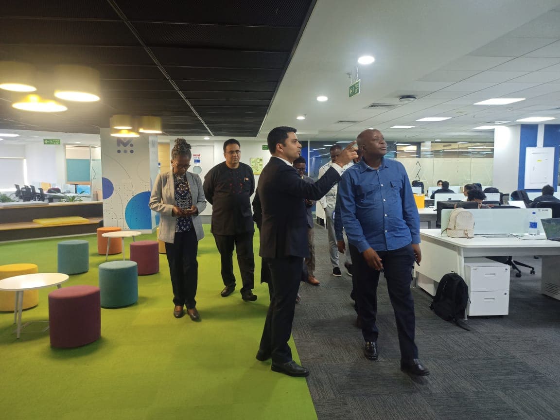 Delegates being guided through a colourful breakout lounge on the engineering floor