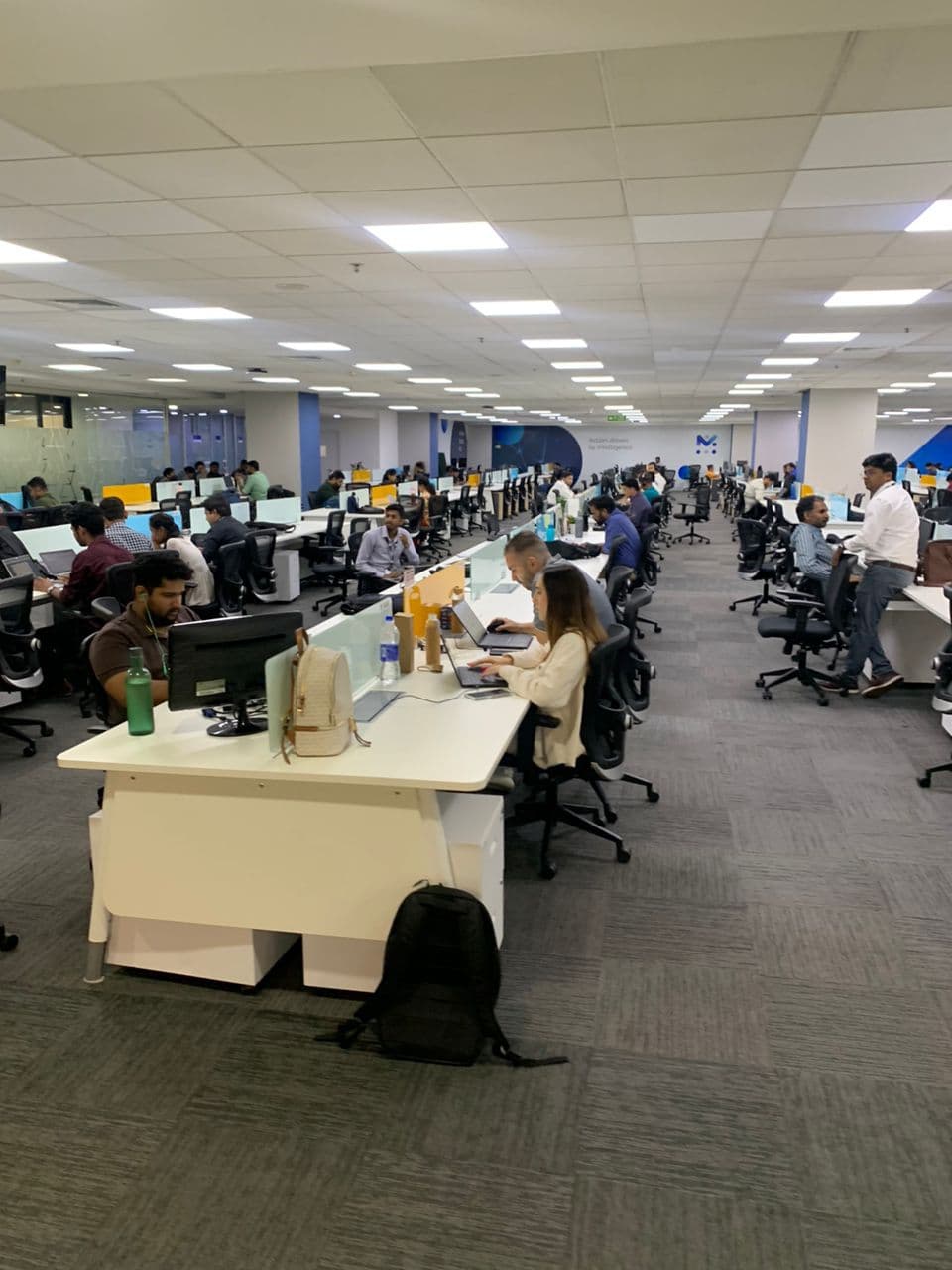 Wide view of Mobileum engineers at their desks on the open-plan engineering floor