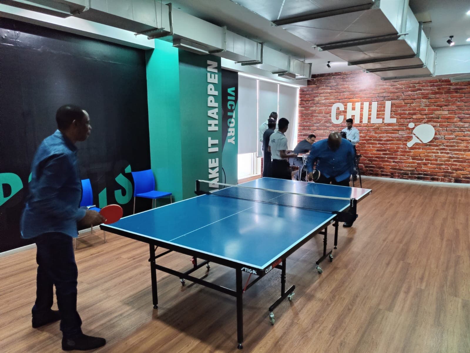 Delegates playing table tennis in the Mobileum office recreation room