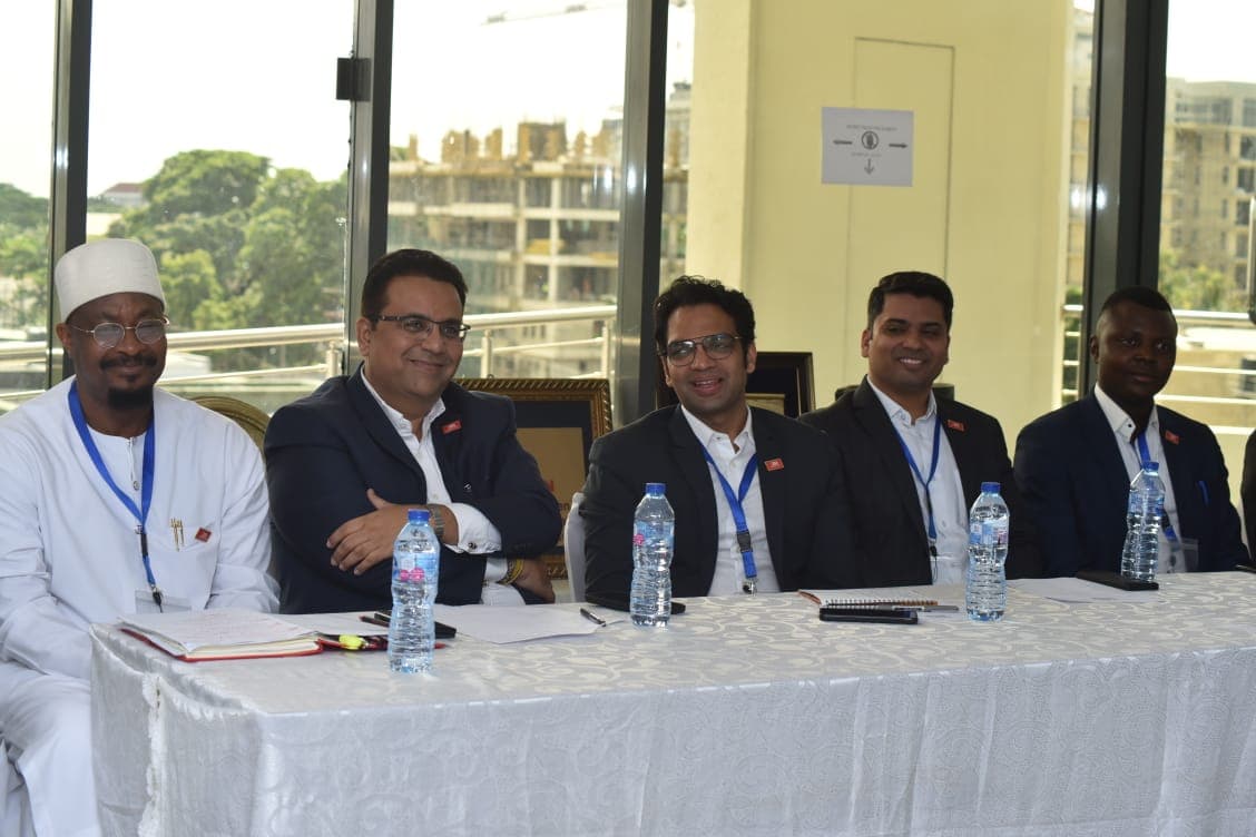 Delegates seated at the table in discussion during the meeting