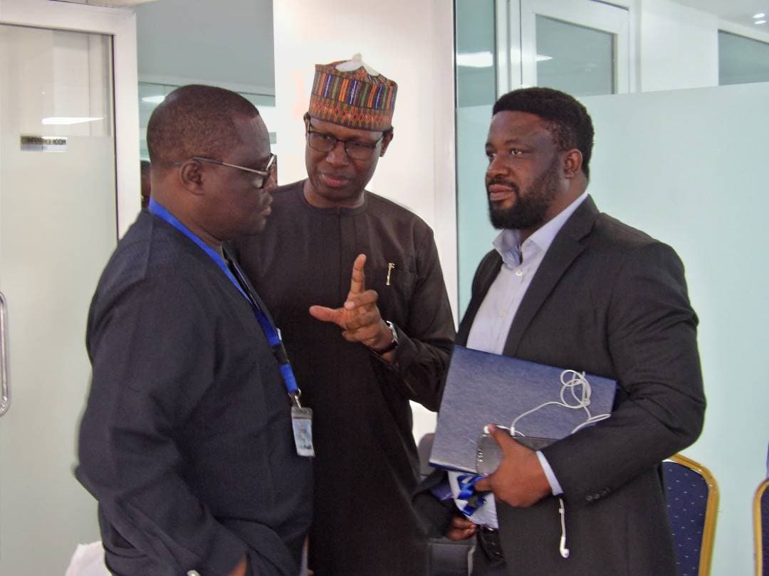 A delegate handing a document folder to another during the meeting