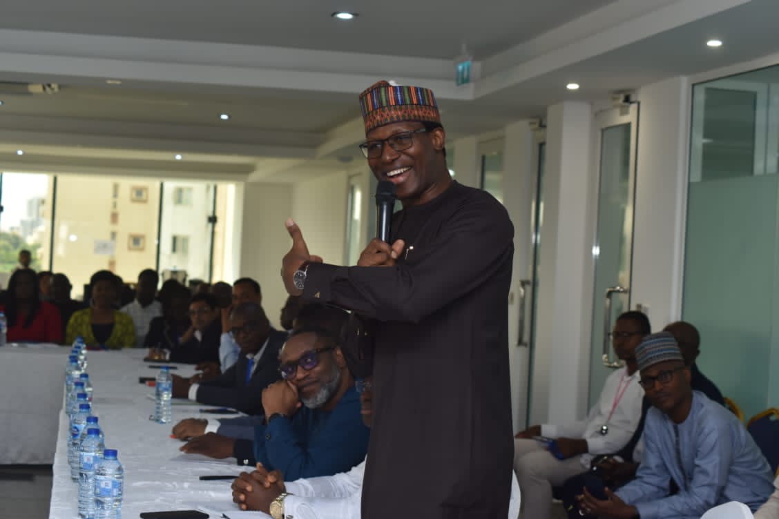 Gbenga Adebayo, President of ALTON, gesturing while addressing seated attendees during the meeting