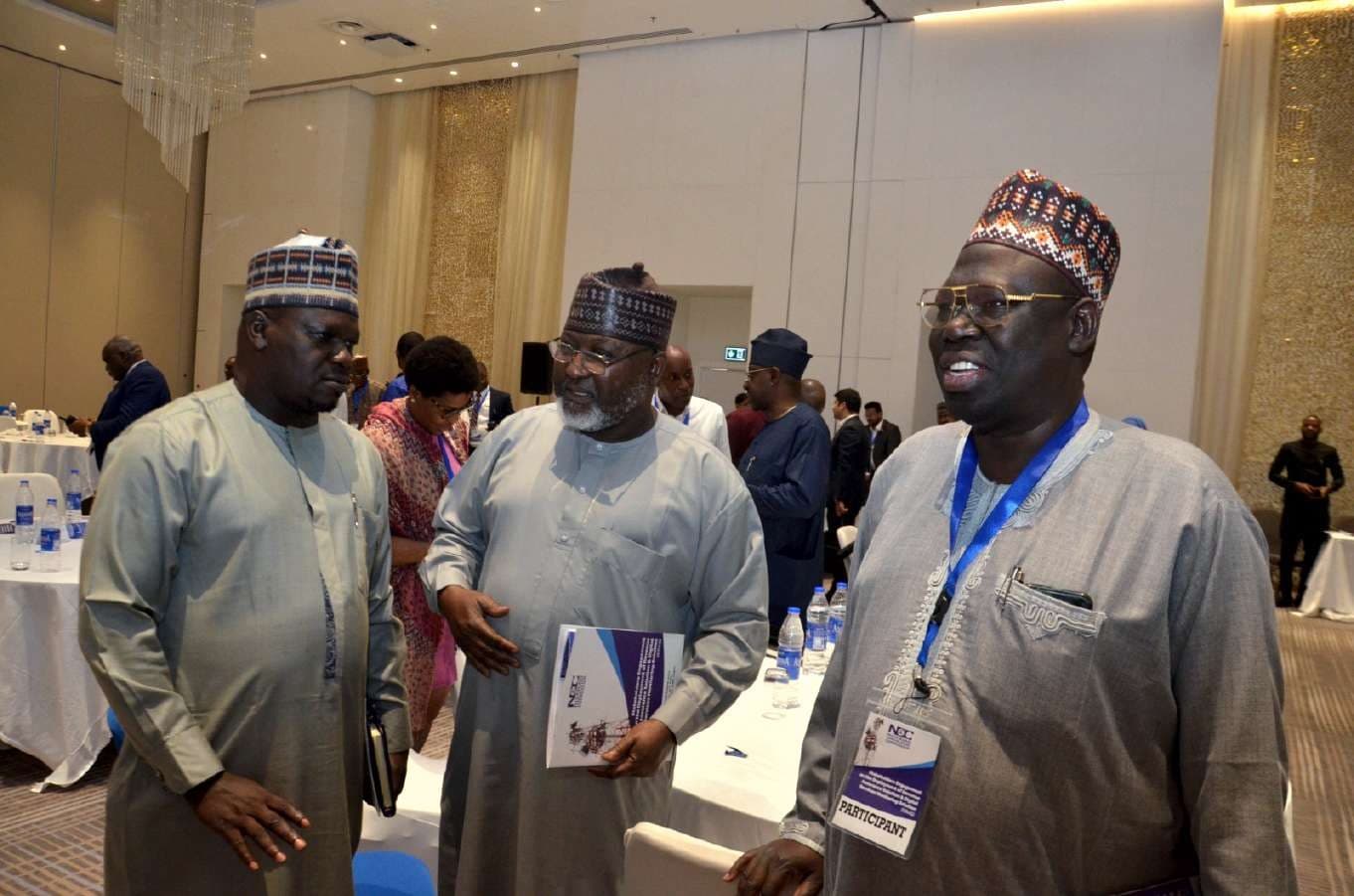 Three delegates in conversation between sessions