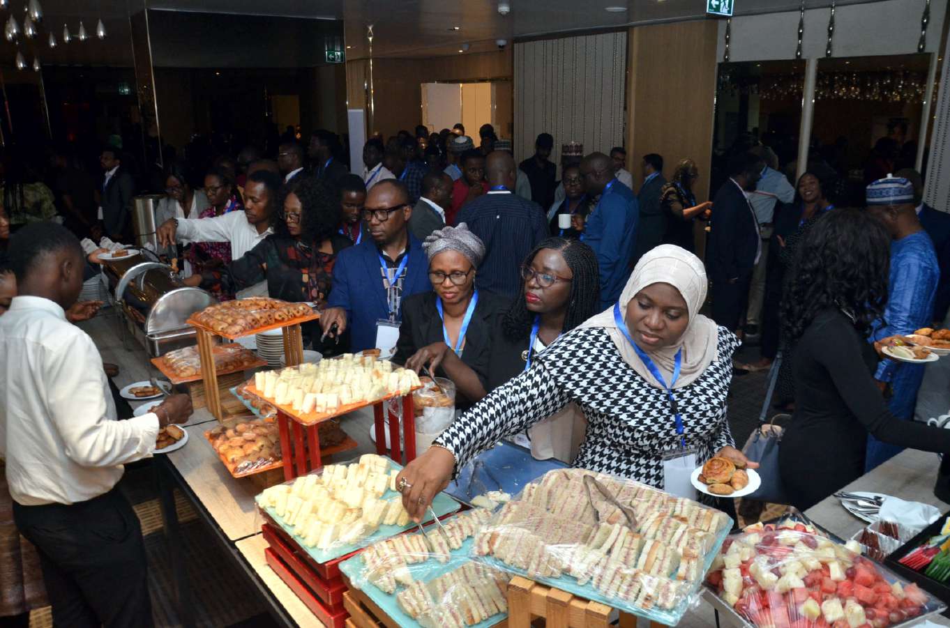Delegates at the refreshment table during a break in proceedings