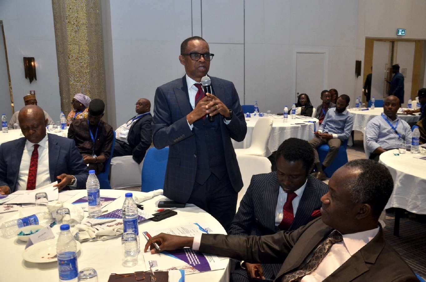 A speaker addressing the full workshop hall