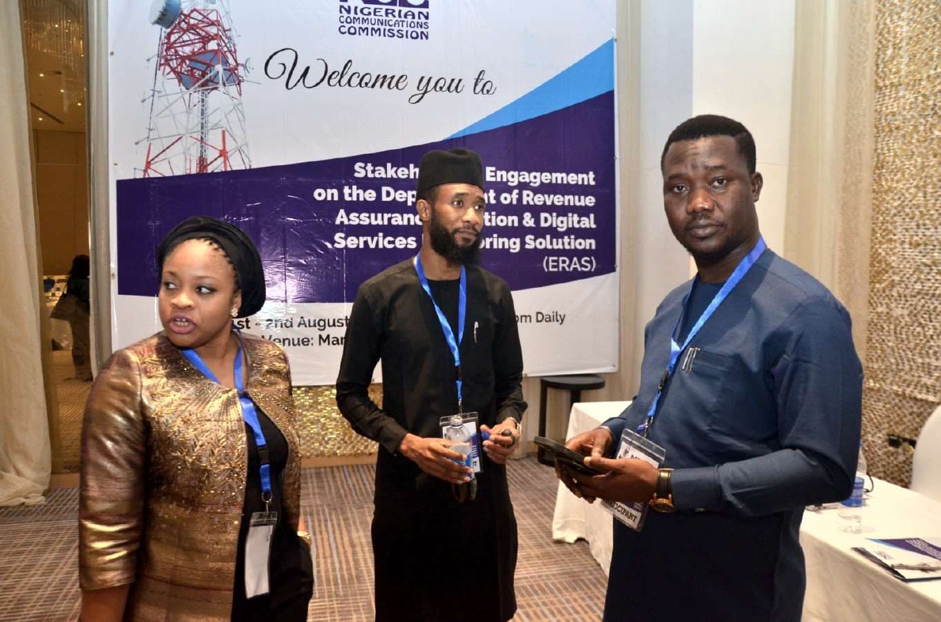 Delegates in front of the NCC welcome banner for the ERAS Stakeholders Workshop
